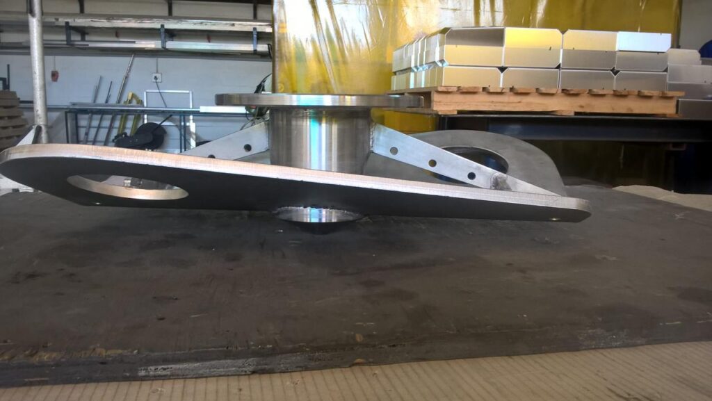 Custom stainless steel base with a machined flange, fabricated on the bench.
