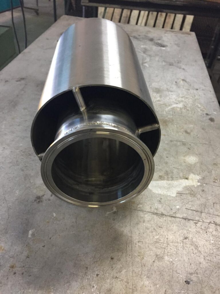 Polished stainless steel roller with a machined flange.