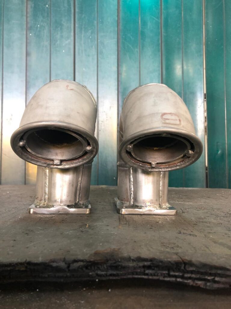 Pair of stainless steel marine exhaust risers.